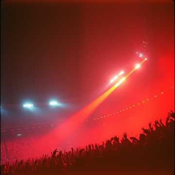 Electric guitar solo playing to a massive stadium crowd